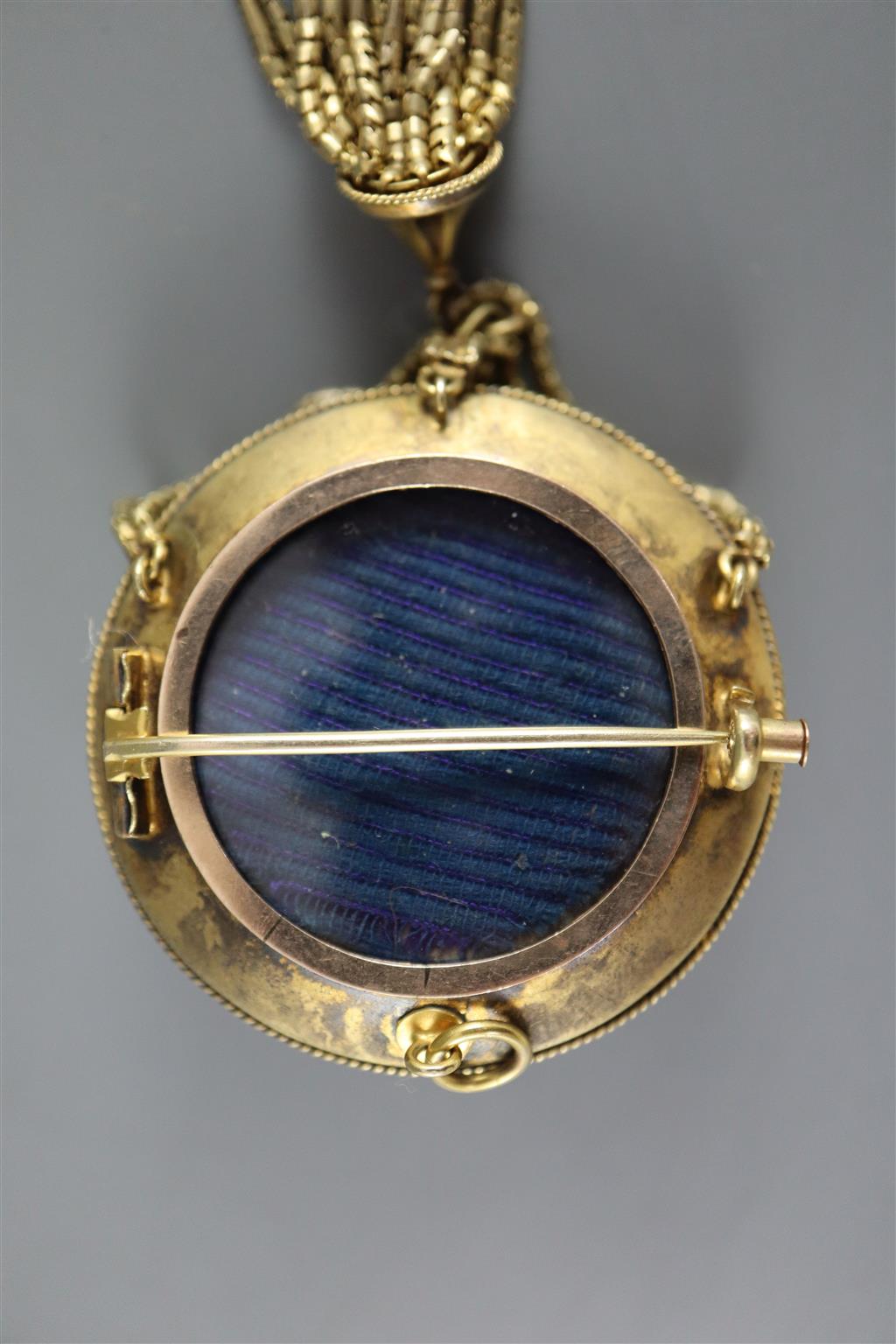 A Victorian gold (tests as 14ct), pearl and blue enamel tassel brooch with central buckle motif and a pair of matching earrings,